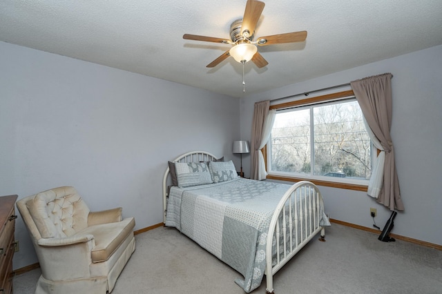 carpeted bedroom with baseboards, a textured ceiling, and ceiling fan