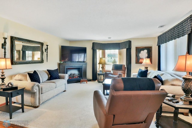 living area featuring a fireplace and carpet flooring