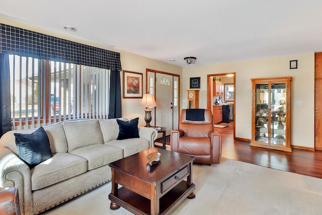 living area with wood finished floors and baseboards