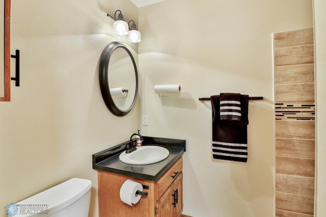 bathroom with toilet and vanity