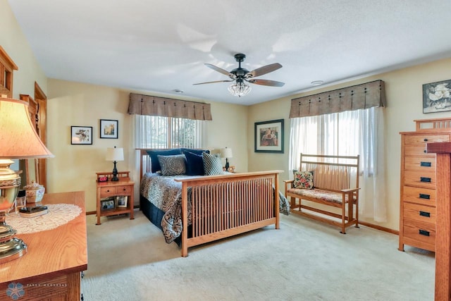 carpeted bedroom with baseboards and multiple windows