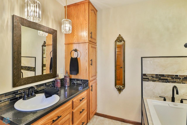 bathroom with vanity, baseboards, a tub, decorative backsplash, and tile patterned flooring