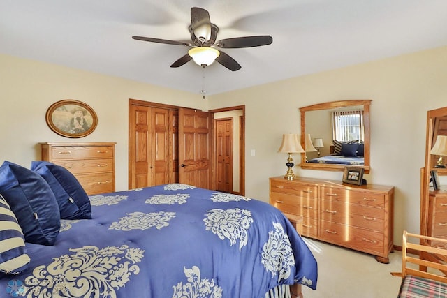 bedroom with a closet, ceiling fan, and carpet floors