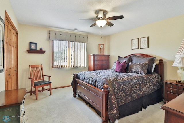 bedroom with baseboards, light carpet, and a ceiling fan