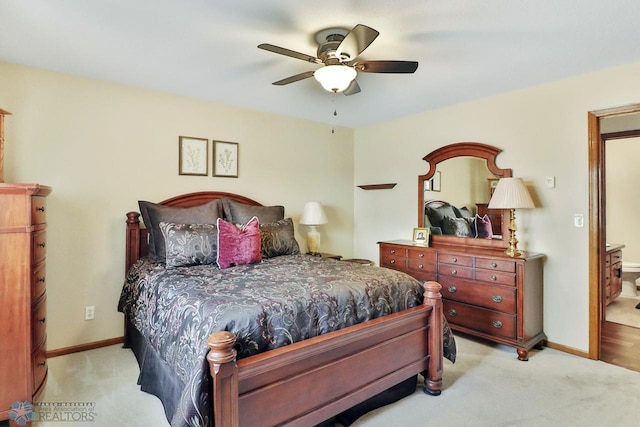 bedroom with light carpet, ceiling fan, and baseboards