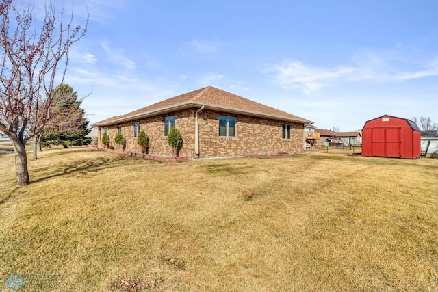 view of side of property with brick siding, a storage shed, an outdoor structure, and a lawn