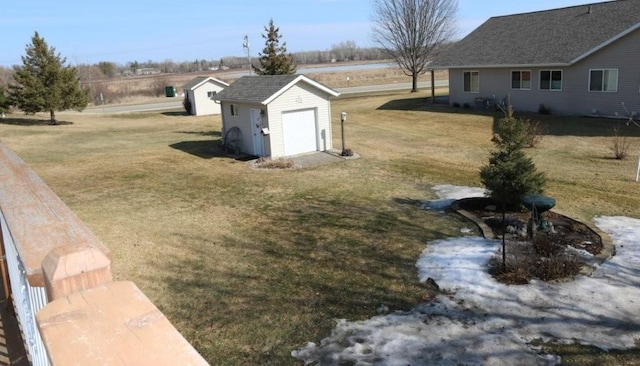 view of yard with an outdoor structure, a storage unit, and a detached garage