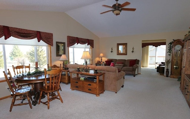 dining room featuring light carpet, high vaulted ceiling, and a ceiling fan