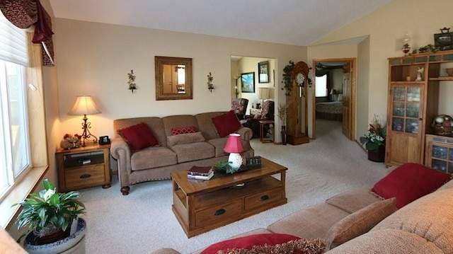 living room featuring light colored carpet and vaulted ceiling