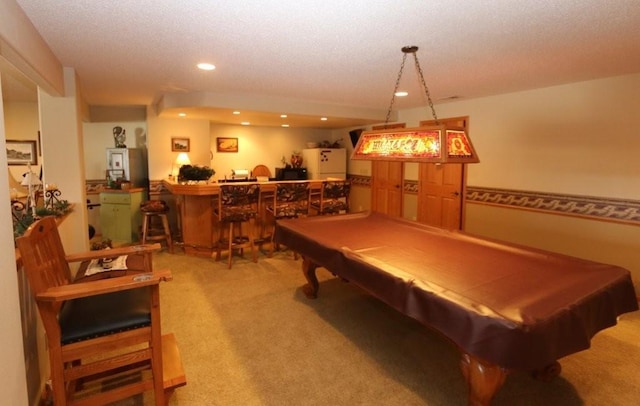 recreation room with carpet, recessed lighting, pool table, bar, and a textured ceiling