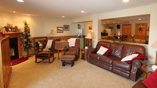 carpeted living area with a fireplace with flush hearth, recessed lighting, and a textured ceiling