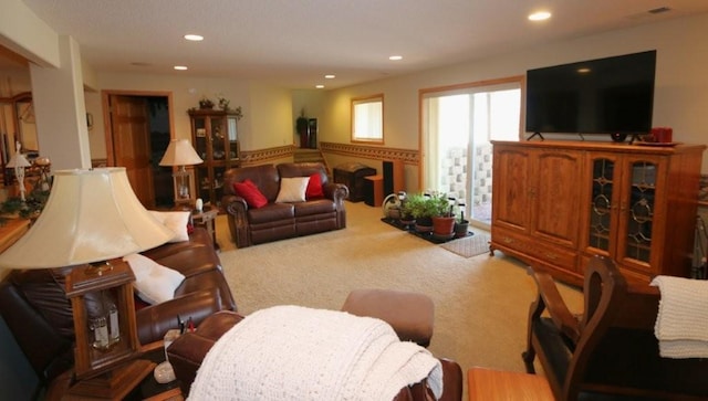 carpeted living room featuring recessed lighting and a wainscoted wall