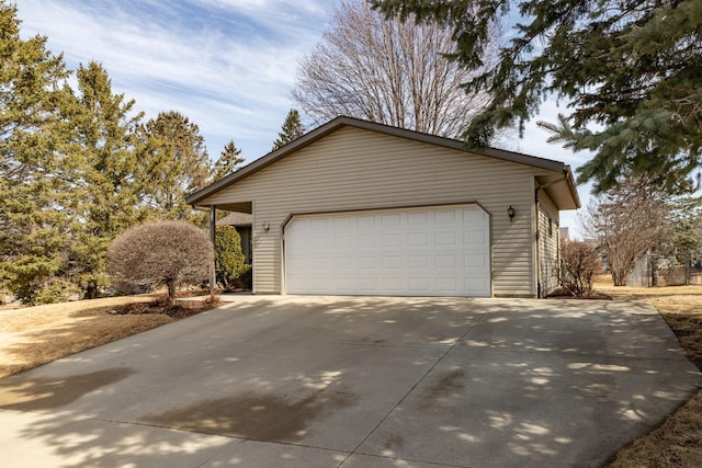 view of side of property with driveway and a garage