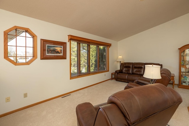 living room with visible vents, carpet floors, baseboards, and vaulted ceiling