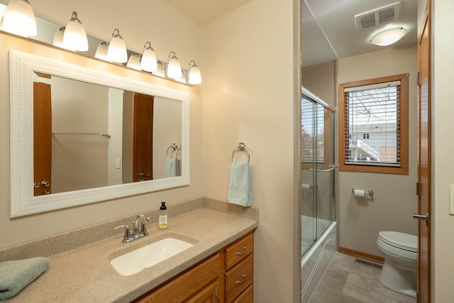 bathroom with vanity, baseboards, visible vents, enclosed tub / shower combo, and toilet