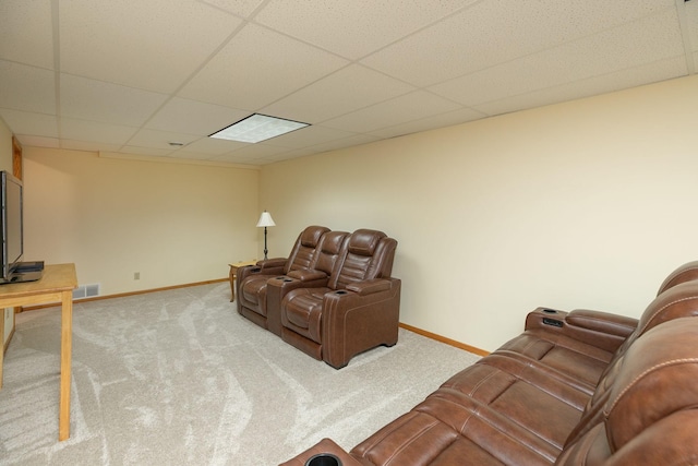 carpeted living room with visible vents, a paneled ceiling, and baseboards