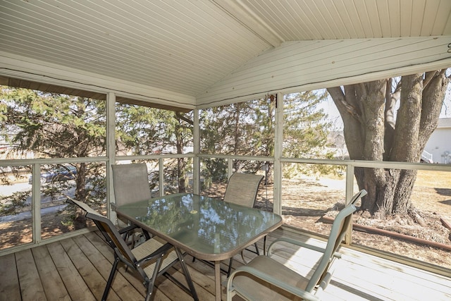 unfurnished sunroom featuring vaulted ceiling