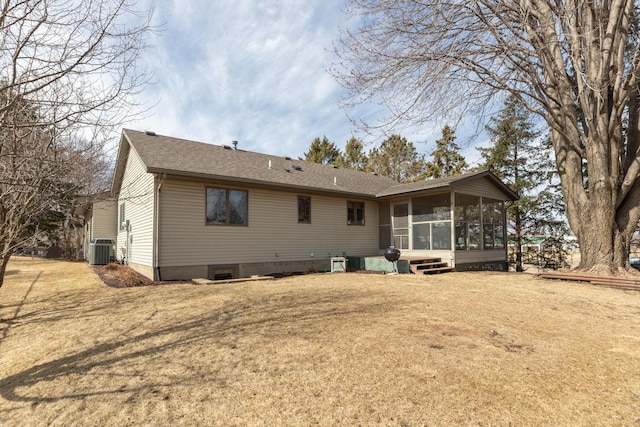 back of property with central AC, a shingled roof, a yard, and a sunroom