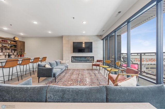 living area with recessed lighting and a fireplace