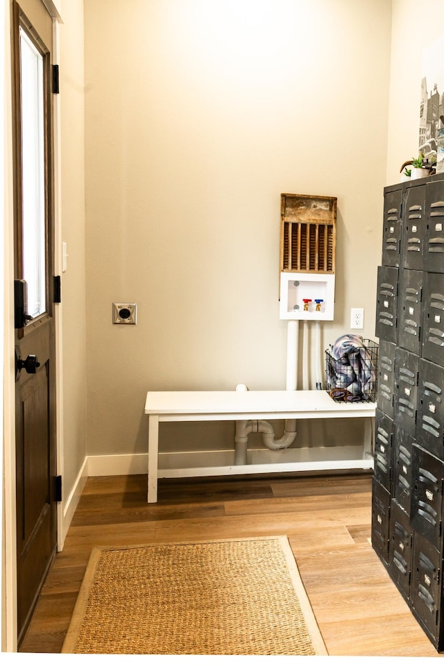 interior space featuring baseboards and wood finished floors