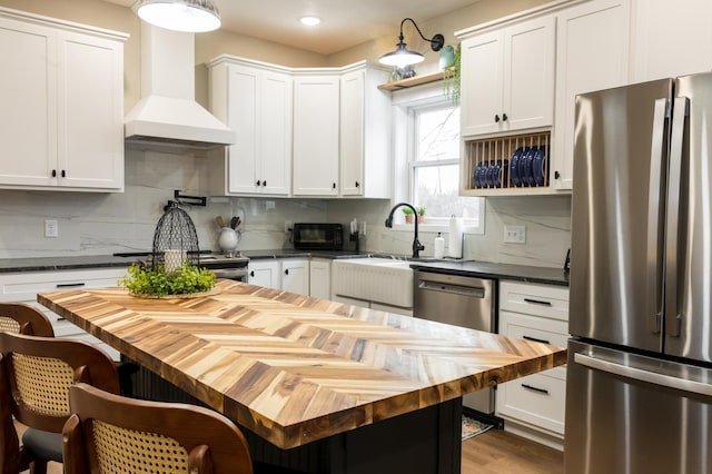 446 Pacific Ave, Hancock, MN 56244 - kitchen with stainless steel appliances, white cabinetry, butcher block countertops, and wall chimney range hood