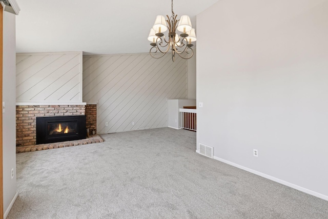 unfurnished living room featuring visible vents, carpet floors, a fireplace, baseboards, and a chandelier