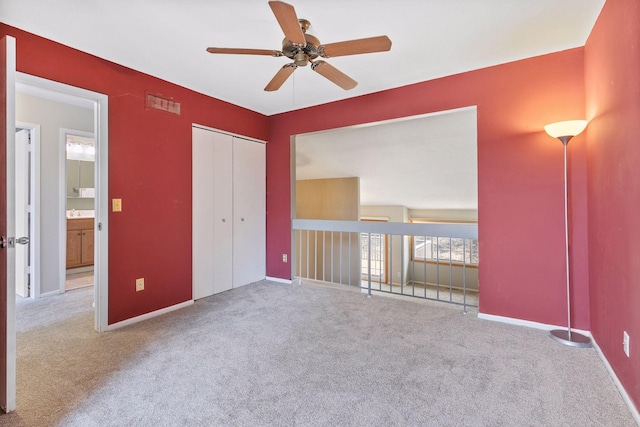 unfurnished bedroom with visible vents, baseboards, a closet, and carpet flooring