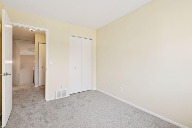 unfurnished bedroom with visible vents, carpet flooring, and baseboards