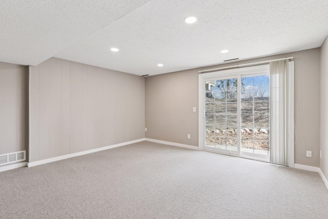 carpeted empty room with visible vents, recessed lighting, a textured ceiling, and baseboards