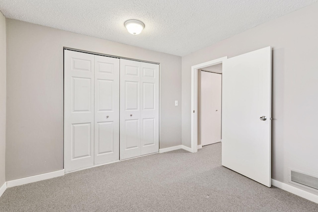 unfurnished bedroom with visible vents, baseboards, and carpet