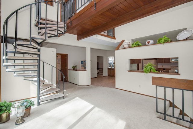 living room with stairway, beam ceiling, carpet, and wooden ceiling