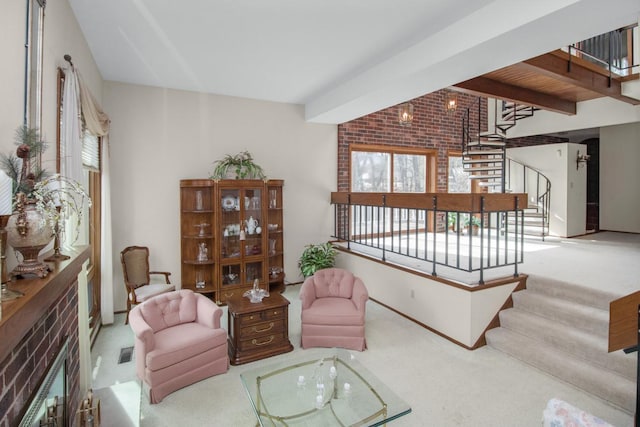 carpeted living area featuring stairway, beamed ceiling, and visible vents