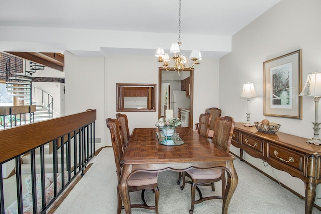 carpeted dining room featuring a chandelier