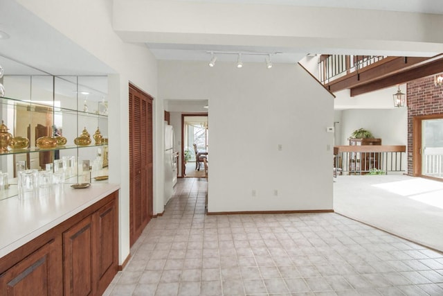 interior space featuring baseboards and track lighting