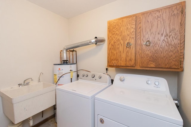 laundry area with washer and clothes dryer, cabinet space, gas water heater, and a sink