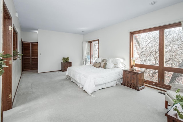 carpeted bedroom featuring visible vents