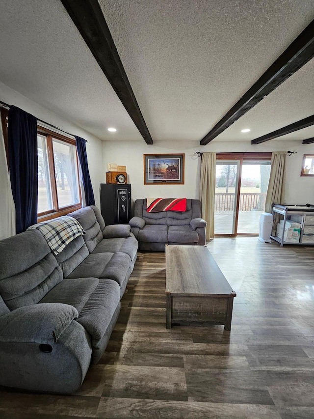 living room with recessed lighting, beamed ceiling, a textured ceiling, and wood finished floors