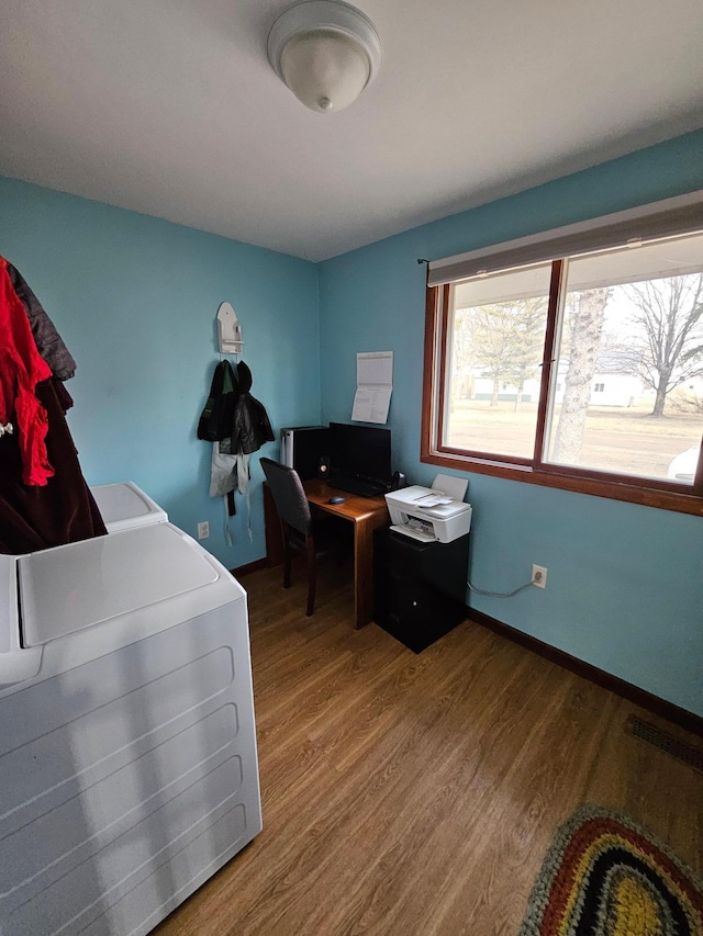 home office featuring visible vents, baseboards, and wood finished floors