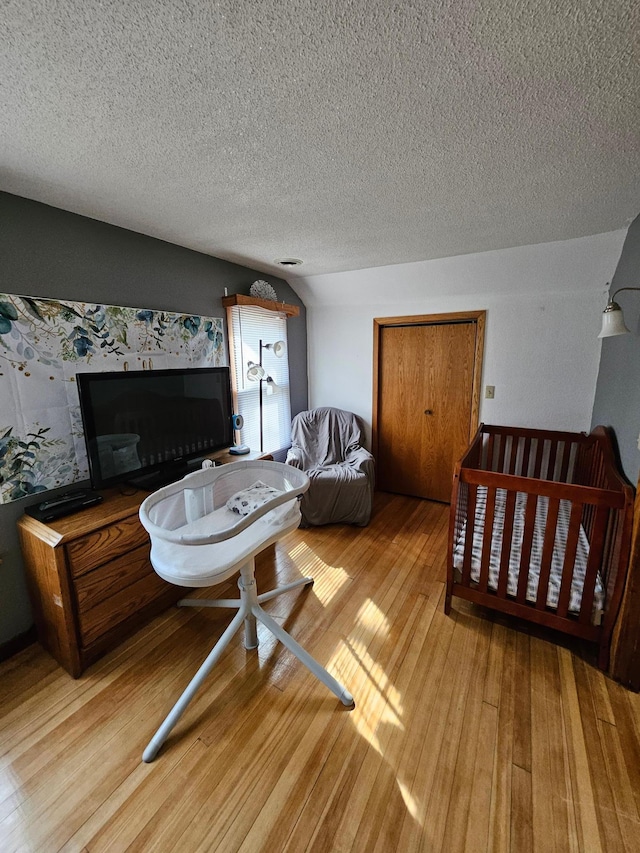 living area with light wood-style floors and a textured ceiling