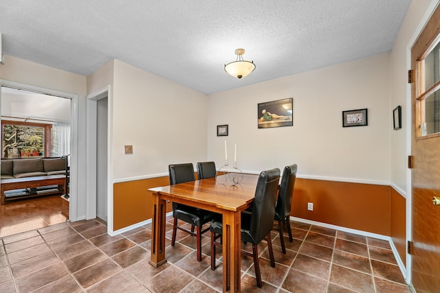 dining area featuring a textured ceiling