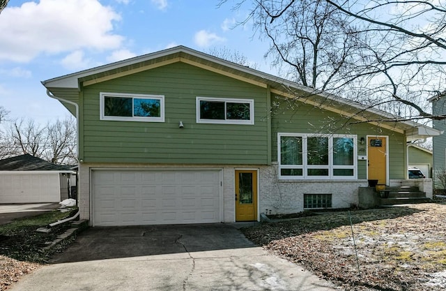 view of front of home with brick siding, an attached garage, and concrete driveway