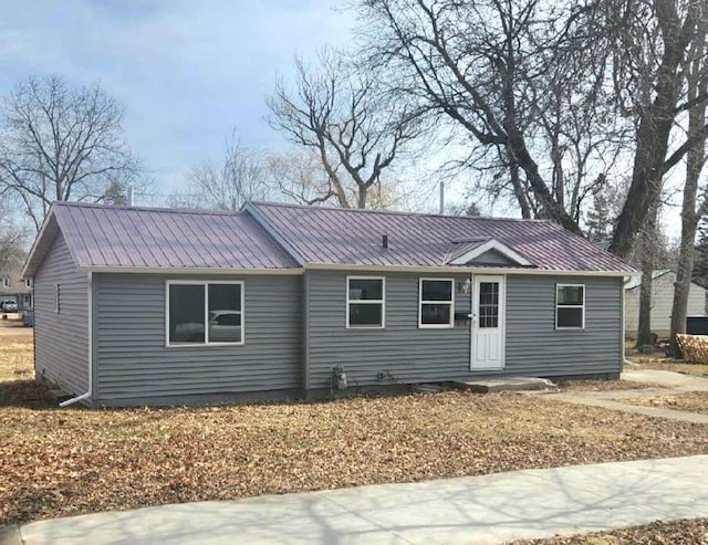 ranch-style home featuring metal roof