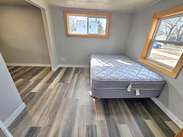 unfurnished bedroom featuring baseboards and wood finished floors