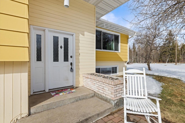 doorway to property featuring brick siding