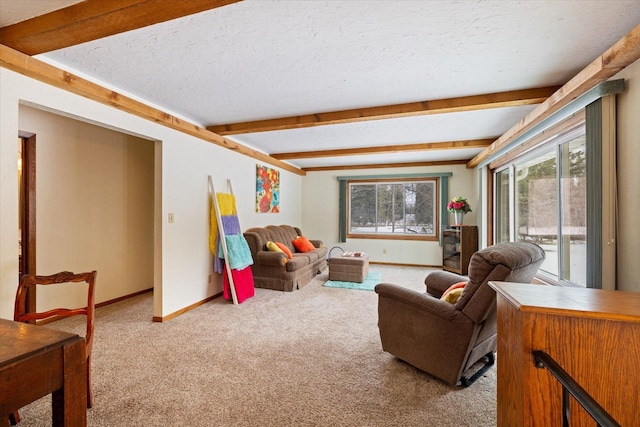 living area with beam ceiling, carpet, baseboards, and a textured ceiling