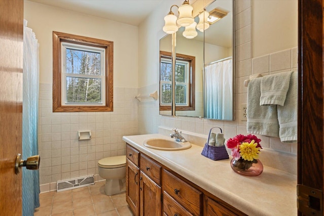 full bathroom with a wealth of natural light, visible vents, tile patterned flooring, and vanity