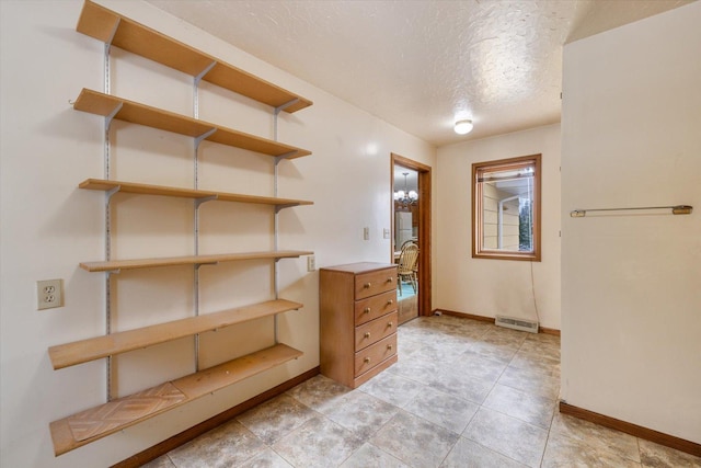 spacious closet featuring visible vents