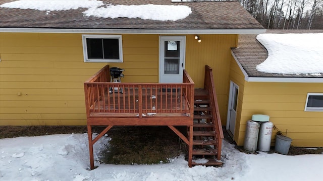 snow covered deck featuring stairs