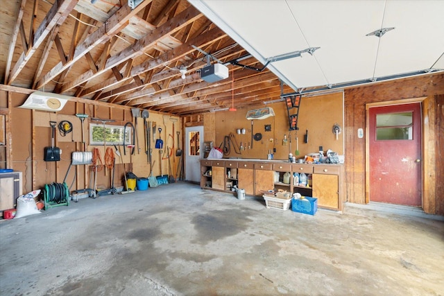 garage with a workshop area and a garage door opener