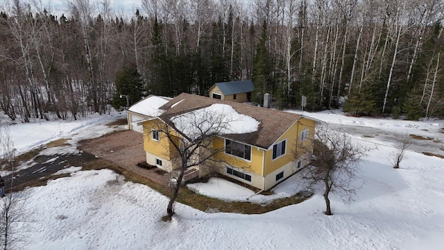 snowy aerial view featuring a view of trees